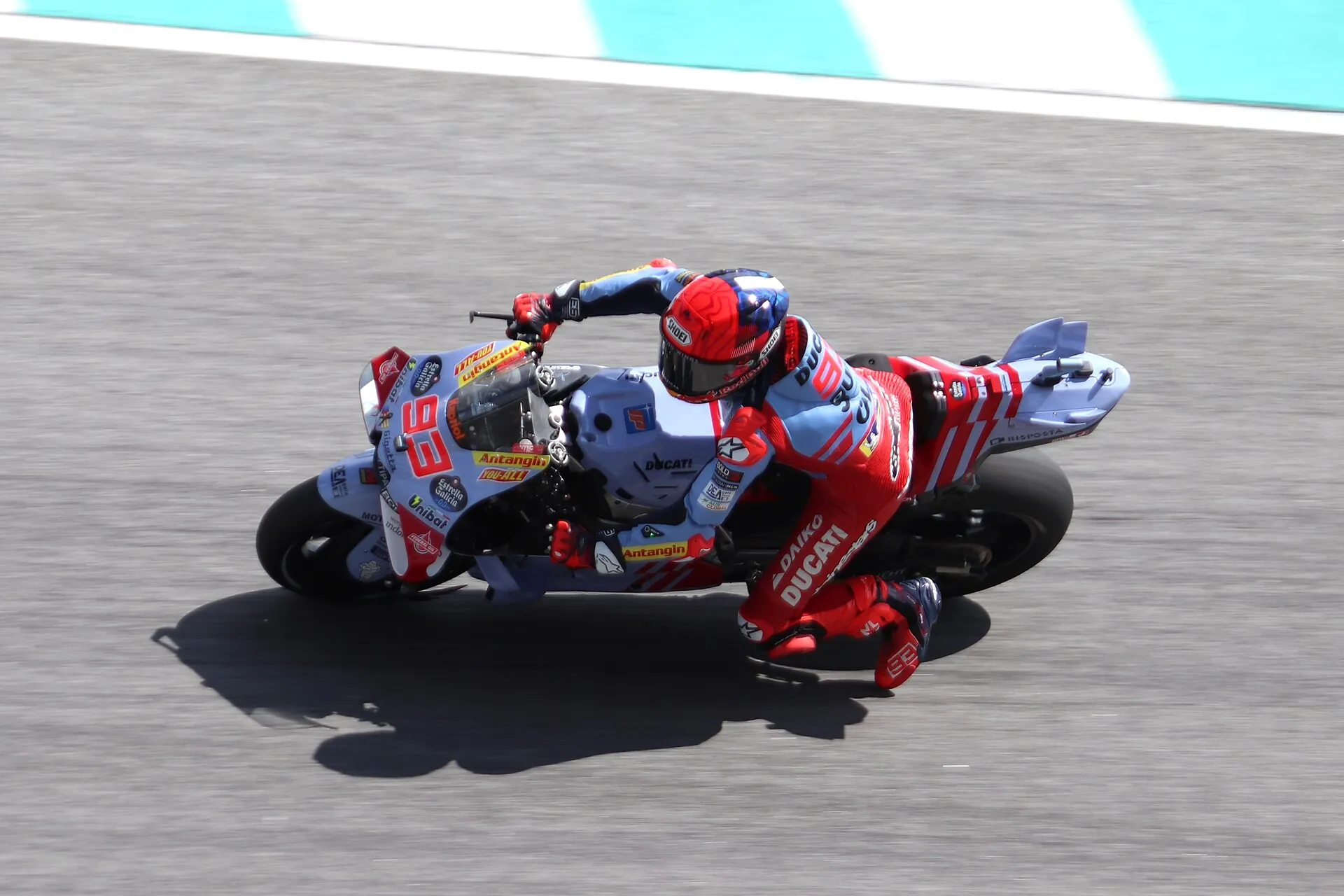 MotoGP rider leaning into a corner at Sepang