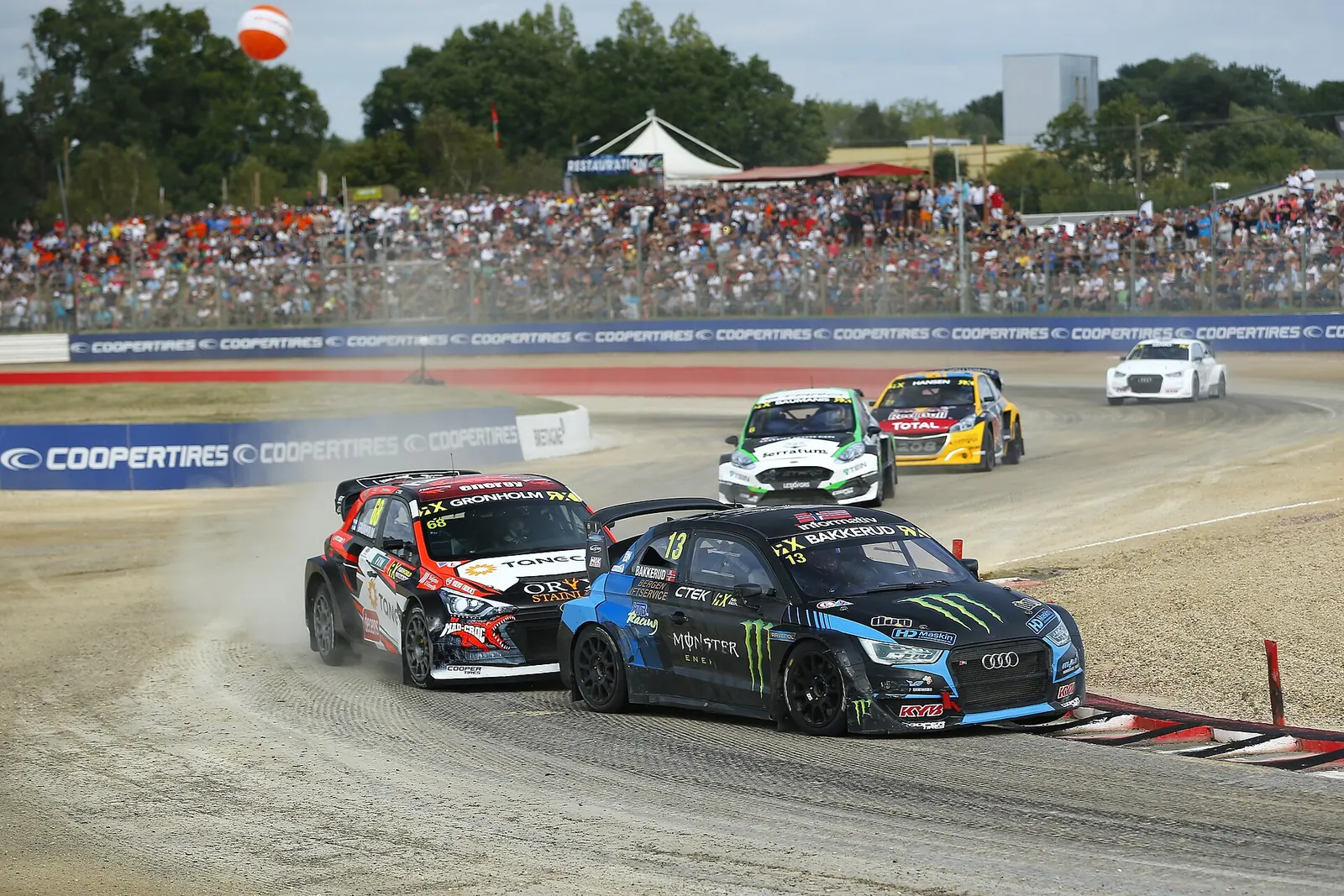 Rallycross cars battling through a corner at Lohéac